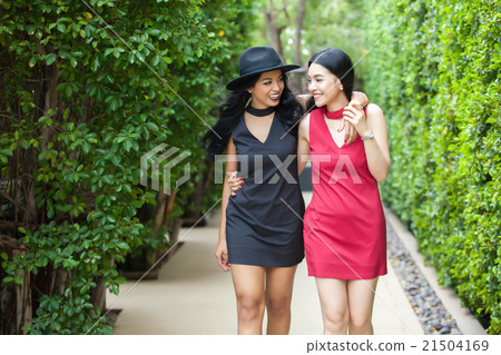 Best friends taking walk together in outdoor park Best friends taking walk together in outdoor park 21504169