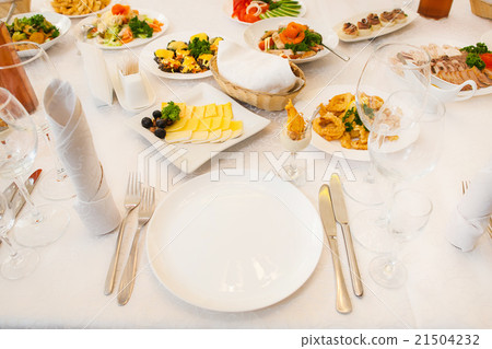 Table served with different food and flatware 21504232