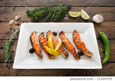 Restaurant food - grilled salmon with lemon. Restaurant food - grilled salmon with lemon. 21504705