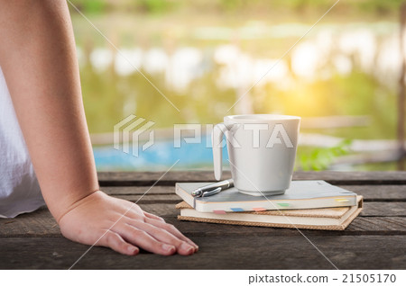 Coffee cup with notebook on rustic wood table 21505170