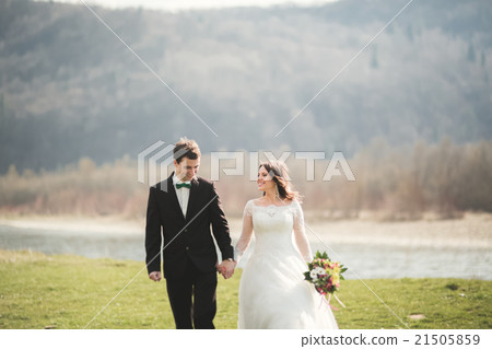 Beautiful wedding couple, bride, groom posing and Beautiful wedding couple, bride, groom posing and 21505859