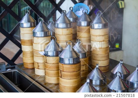 Dumplings cooking inside traditional bamboo Dumplings cooking inside traditional bamboo 21507818