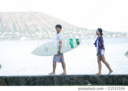 A couple walking along the beach A couple walking along the beach 21515104