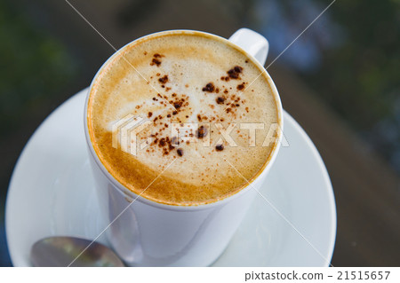 Cup of art latte on a cappuccino coffee 21515657