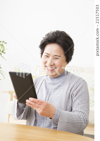 Senior woman operating a tablet Senior woman operating a tablet 21517503