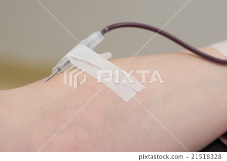 Donor in an armchair donates blood,, close-up 21518328