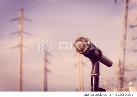 microphone on a stand with blurred electric posts microphone on a stand with blurred electric posts 21520162