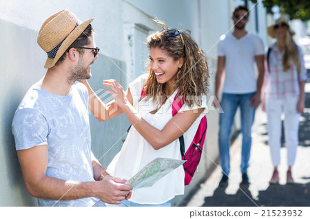 Hip couple holding map and laughing 21523932
