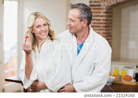 Cute couple cuddling in bathrobes 21524168