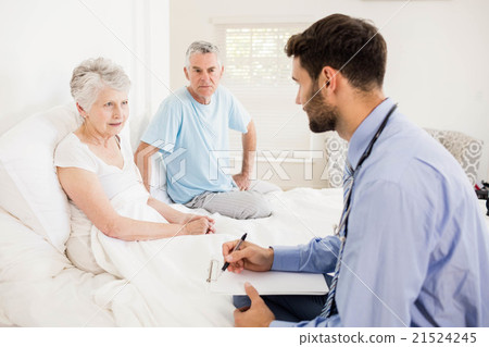 Handsome nurse visiting a mature woman 21524245
