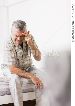 Suffering senior man touching his forehead Suffering senior man touching his forehead 21524255