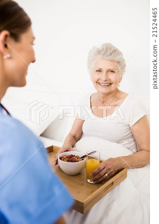 Nurse taking care of suffering senior patient Nurse taking care of suffering senior patient 21524465