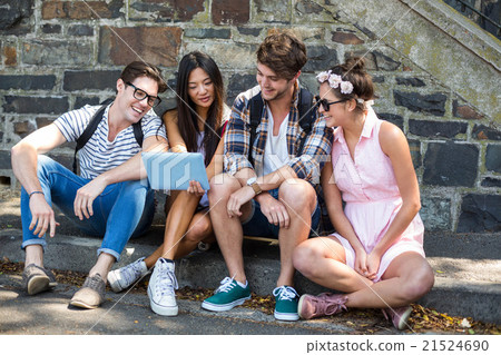 Hip friends looking at tablet 21524690