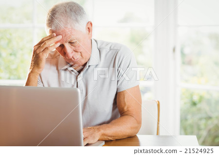 Worried senior man using laptop Worried senior man using laptop 21524925