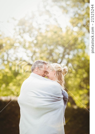 Cute couple hugging with a blanket around 21525244