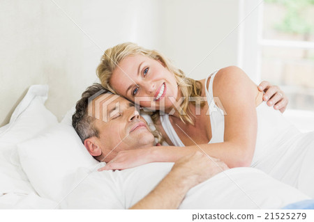 Cute couple cuddling in bed 21525279