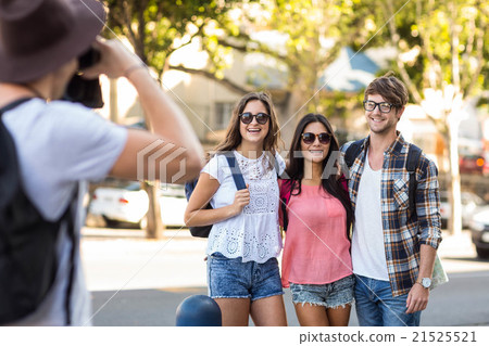 Hip man taking picture of his friends 21525521