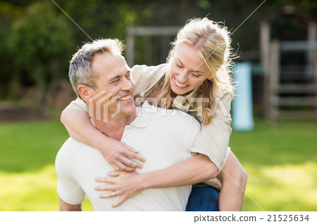 Husband giving piggy back to wife 21525634