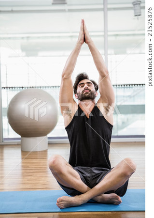Handsome man doing yoga on mat 21525876