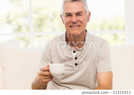 Smiling senior man holding mug Smiling senior man holding mug 21525913