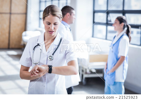 Nurse checking her smart watch 21525923