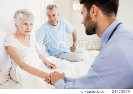 Handsome nurse holding hand of mature woman 21525979