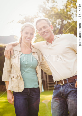 Cute couple with arms around Cute couple with arms around 21526216