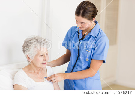 Doctor taking care of suffering senior patient Doctor taking care of suffering senior patient 21526217