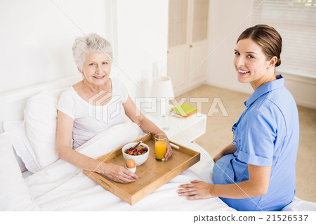 Nurse taking care of suffering senior patient 21526537