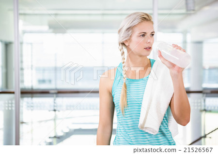 Smiling blonde drinking water Smiling blonde drinking water 21526567