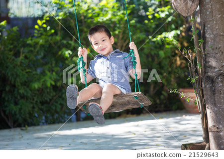 Asian baby boy playing on a swing Asian baby boy playing on a swing 21529643