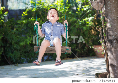 Asian baby boy playing on a swing Asian baby boy playing on a swing 21529644