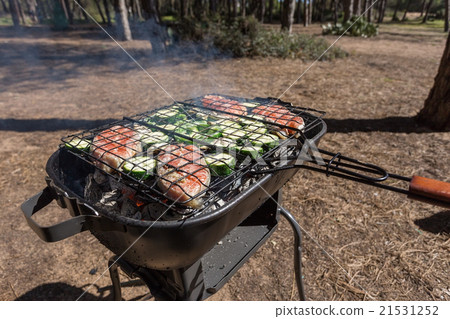 Picnic cooking outdoors with a grill. Picnic cooking outdoors with a grill. 21531252