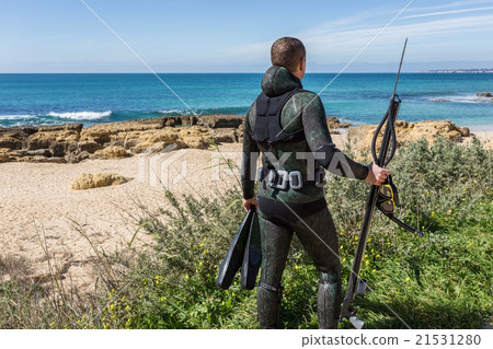Underwater hunter with a gun in mask. Underwater hunter with a gun in mask. 21531280
