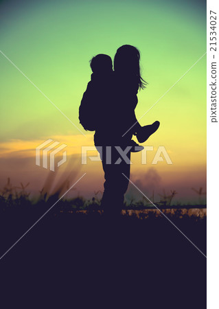 Silhouette of mother and child enjoying the view. Silhouette of mother and child enjoying the view. 21534027