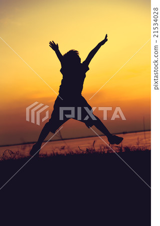 Silhouette of child enjoying the view at riverside Silhouette of child enjoying the view at riverside 21534028