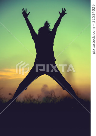 Silhouette of woman jumping against sunset. Silhouette of woman jumping against sunset. 21534029