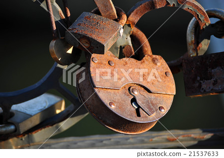The couple hung a lock on the bridge railing The couple hung a lock on the bridge railing 21537633