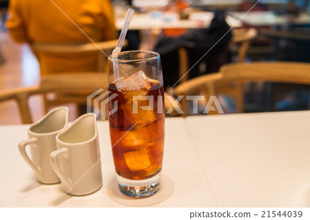 Ice tea in glass with cup of cream and syrup 21544039