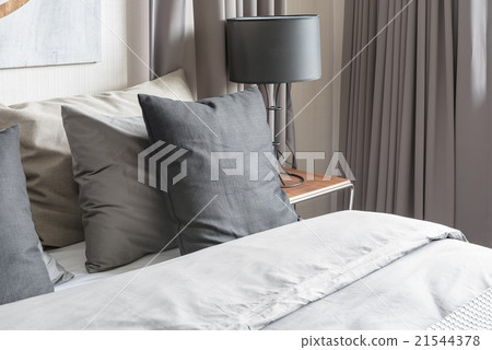 grey pillow on white bed in modern bedroom grey pillow on white bed in modern bedroom 21544378