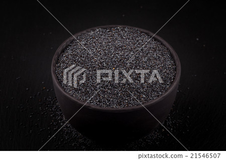poppy seeds in a stone bowl 21546507