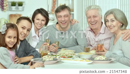 family at the table with tasty food 21547348