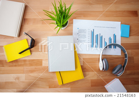 Writing-pads with earphones on the table 21548163