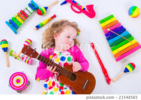 Little girl with music instruments 21548565