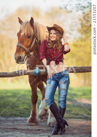 Horse and girl with cowboy hat Horse and girl with cowboy hat 21553207