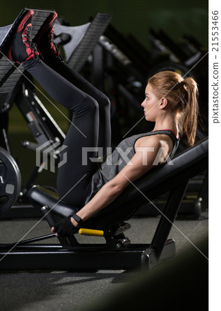 Sportive woman using weights press machine for Sportive woman using weights press machine for 21553466