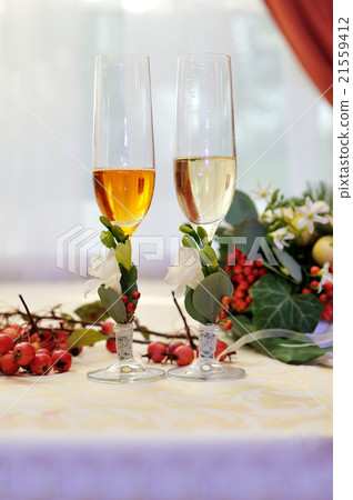 Two glasses of champagne on wedding table Two glasses of champagne on wedding table 21559412