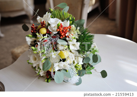 Wedding bouquet of bride lying on table 21559413