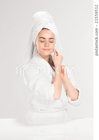 Woman cleaning face in bathroom 21559512