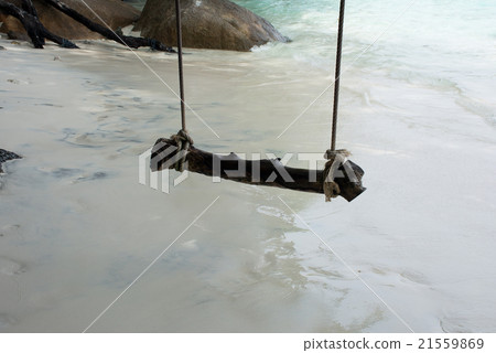 Swing against with sea waves in shade Swing against with sea waves in shade 21559869